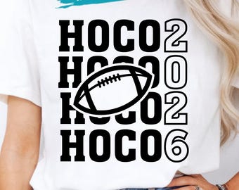 May include: A white t-shirt featuring a black graphic design with the text HOCO 2026 repeated four times in a stacked layout. A black outline of an American football is centered over the text. A teal banner at the top reads IN COLORS.