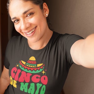 May include: A black t-shirt with a colorful graphic of a sombrero and the text "Cinco de Mayo".