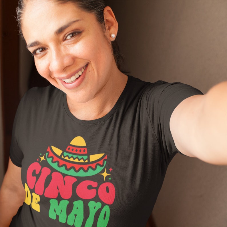 May include: A black t-shirt with a colorful graphic of a sombrero and the text "Cinco de Mayo".