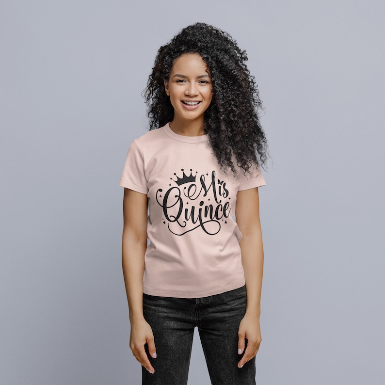 May include: A pink t-shirt with a black crown and the text "Mis Quince" in a decorative script font.