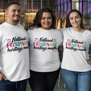 May include: Three people wearing white t-shirts with the text "National Hispanic heritage month" printed in colorful letters. The shirts are a celebration of Hispanic heritage.