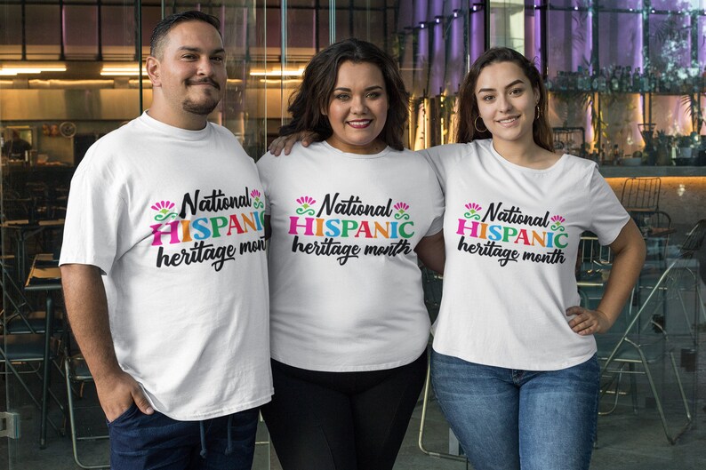 May include: Three people wearing white t-shirts with the text "National Hispanic heritage month" printed in colorful letters. The shirts are a celebration of Hispanic heritage.