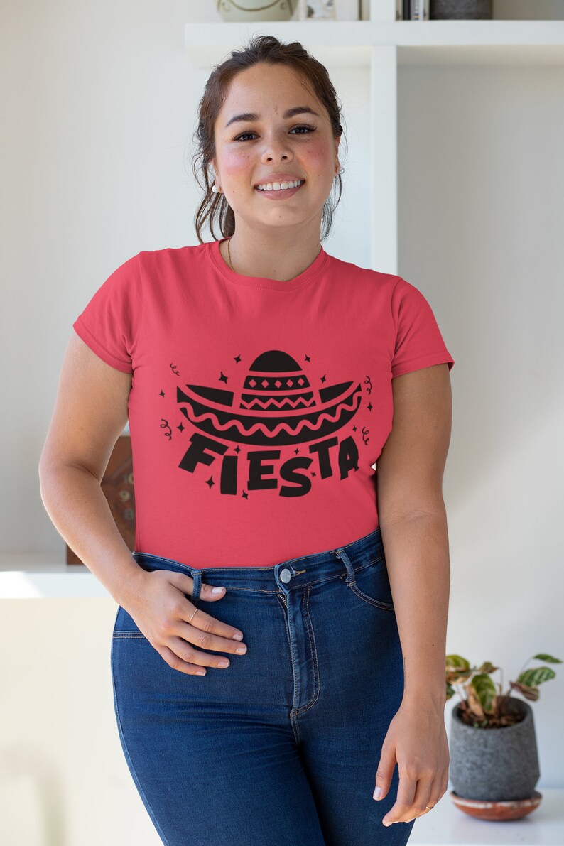 May include: A red t-shirt with a black graphic of a sombrero and the word "FIESTA" on it.