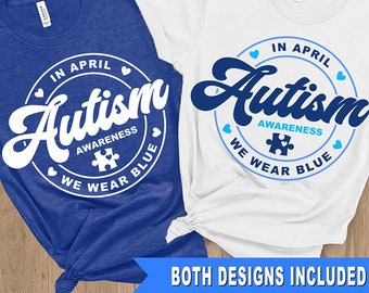 May include: Two t-shirt designs featuring a blue circle with white text that reads "In April Autism Awareness We Wear Blue". The text is in a retro font style. One design has a white circle on a blue shirt and the other has a blue circle on a white shirt. Both designs include a blue puzzle piece.