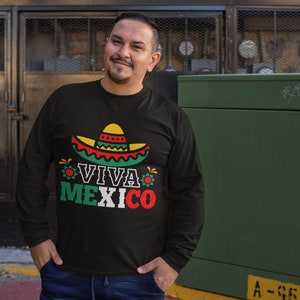 May include: Black long-sleeve shirt with a colorful graphic of a sombrero and the text "Viva Mexico".