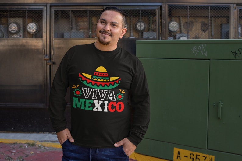 May include: Black long-sleeve shirt with a colorful graphic of a sombrero and the text "Viva Mexico".