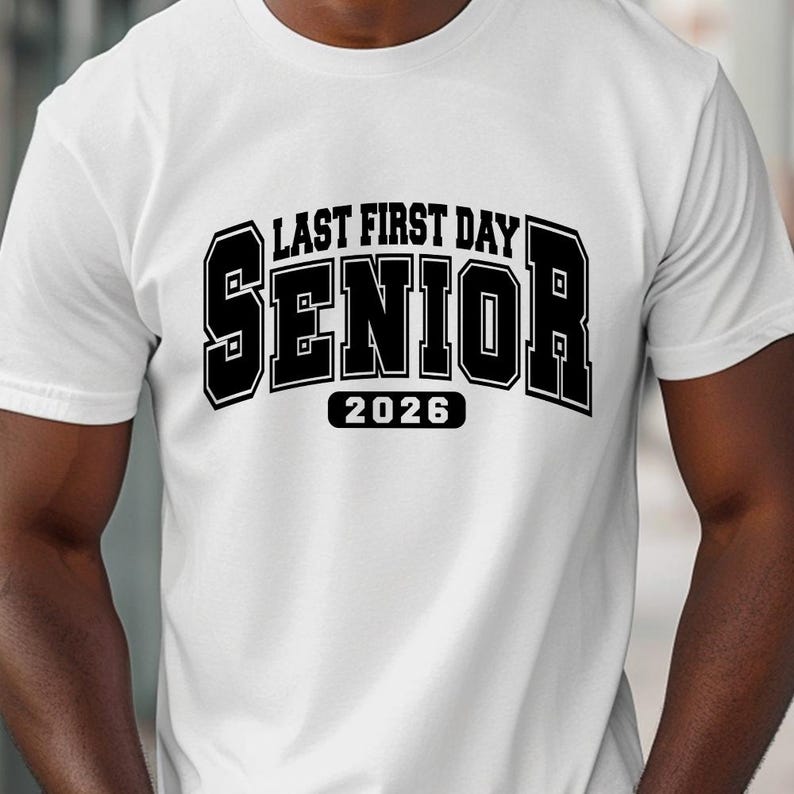 May include: White t-shirt featuring the text "LAST FIRST DAY SENIOR 2026" in a bold, black, block letter design. The shirt is made of a soft material and is suitable for casual wear. The design is centered on the front of the shirt.