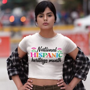 May include: A white crop top with the text "National HISPANIC heritage month" in colorful letters.