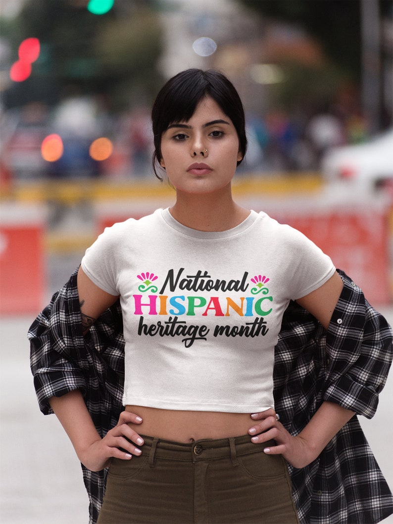 May include: A white crop top with the text "National HISPANIC heritage month" in colorful letters.