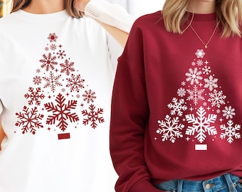 May include: Two images of a white and a red sweatshirt with a Christmas tree design made of snowflakes. The snowflakes are red on the white sweatshirt and white on the red sweatshirt. The text "DIGITAL FILES INSTANT DOWNLOAD" is at the top of the image. The text "BLUE OCEAN SVG PNG DXF JPG EPS" is at the bottom of the image.