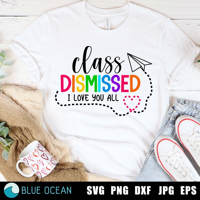 May include: White t-shirt with the text "class DISMISSED I love you all" in rainbow colours. A paper aeroplane and a heart are included in the design.