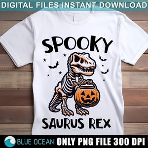 May include: White t-shirt with a black and orange graphic of a skeleton dinosaur holding a jack-o-lantern. The text "Spooky Saurus Rex" is printed below the dinosaur.