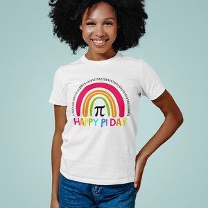 May include: White t-shirt featuring a rainbow design with the text "HAPPY PI DAY". The rainbow includes the mathematical symbol &pi; and a series of numbers. The shirt is made of a soft material.