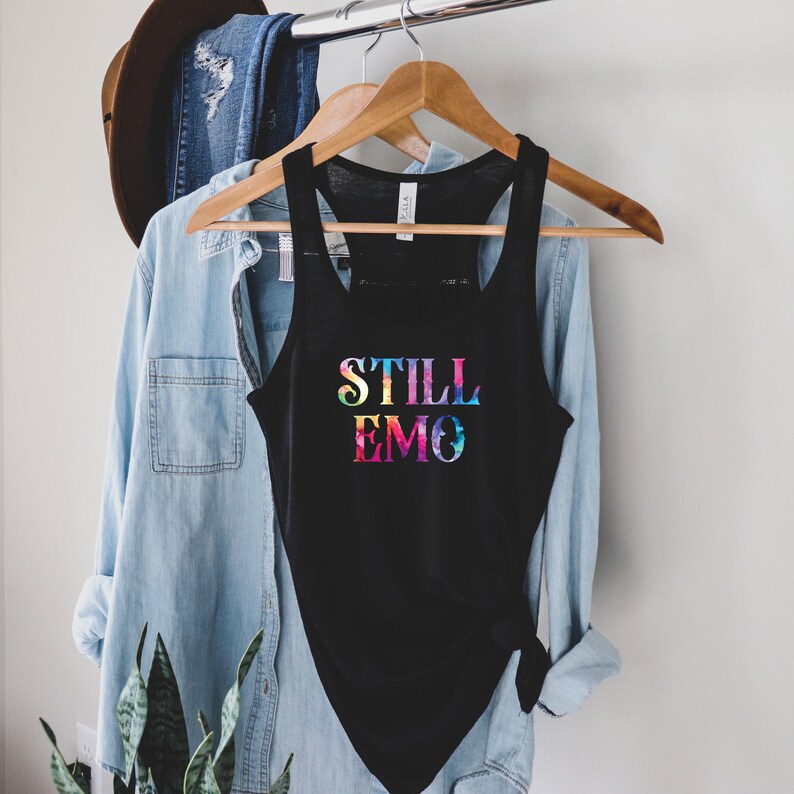 May include: A black tank top with a rainbow gradient graphic that says "STILL EMO".