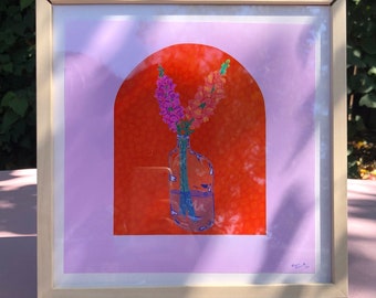 May include: A framed print of a still life featuring a vase of pink flowers in front of an orange archway. The vase is clear glass and the flowers are pink and orange.