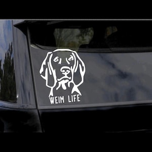 May include: White vinyl sticker of a Weimaraner dog's head with the text "Weim Life" underneath.