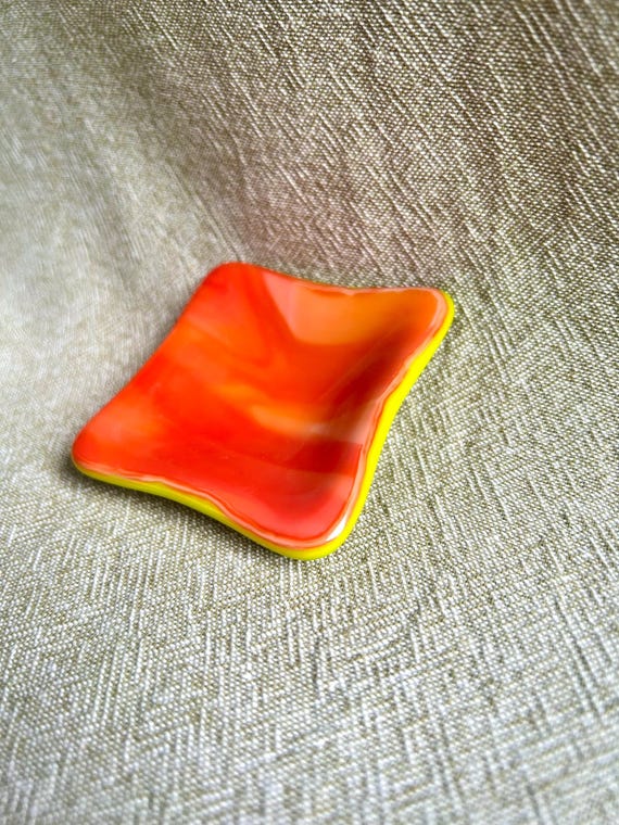 A hand-blown colorful glass catchall dish — each one genuinely unique, with the kind of swirled color you can't get from a factory.
