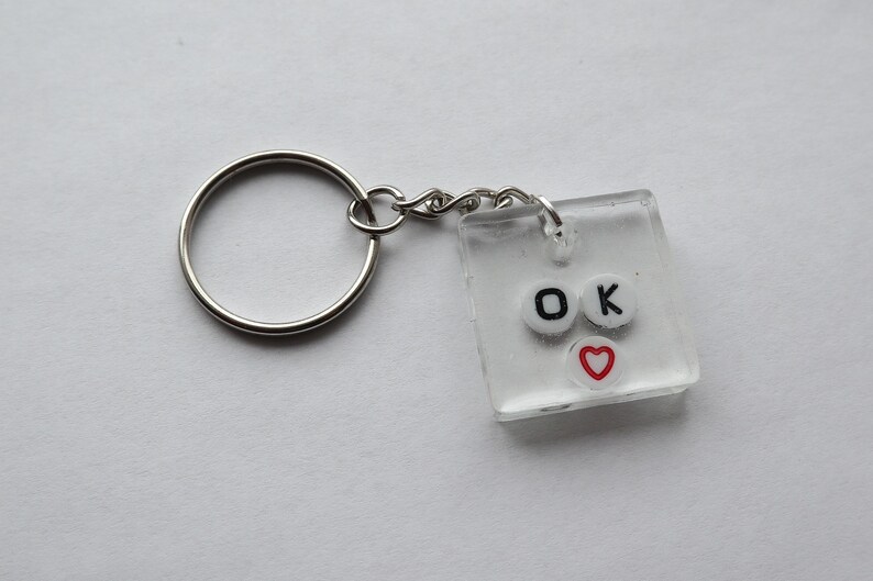 Ok 100/% handmade and made to order this adorable keychain is perfect for any quirky fun key or purse nont This item is made from clear