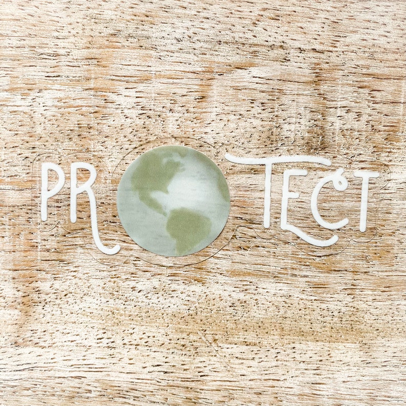 May include: White lettering on a wood background reads "PROTECT" with a green and white globe in the center.
