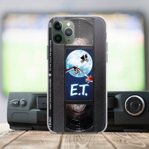 May include: A black and silver iPhone case with a vintage VHS tape design. The case features a scene from the movie E.T. with the text "E.T." printed on the case.