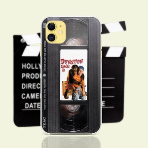 May include: A black and silver phone case with a vintage VHS tape design. The case features a movie poster for the film "Dunston Checks In" with a monkey and a boy on the cover.
