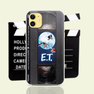 May include: A black and silver phone case with a vintage VHS tape design. The case features a scene from the movie E.T. with the text "E.T." printed on the case.