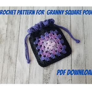 May include: Crochet pattern for a granny square pouch. The pouch is made with black and purple yarn and has a drawstring closure. PDF download.