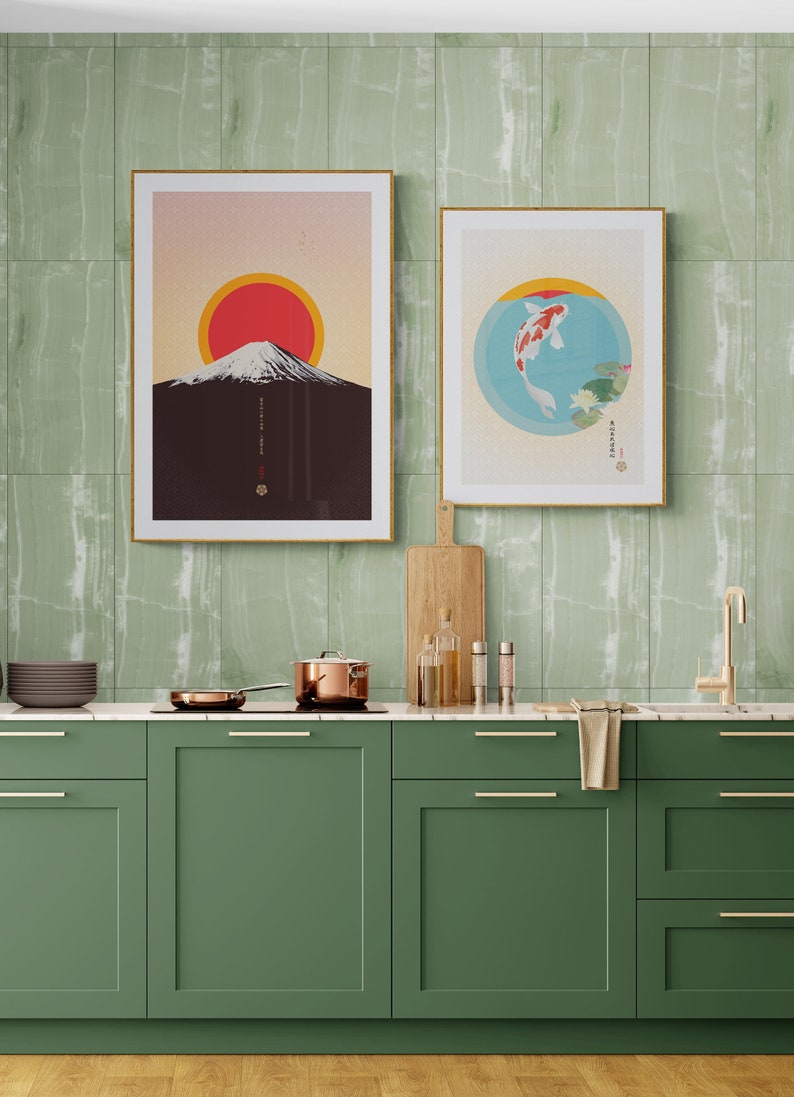 May include: A green kitchen with a marble countertop and green cabinets. There are two framed prints on the wall, one with a mountain and a red sun, and the other with a fish in a circle. There are cooking supplies on the counter, including a pot, a pan, and bottles of oil.