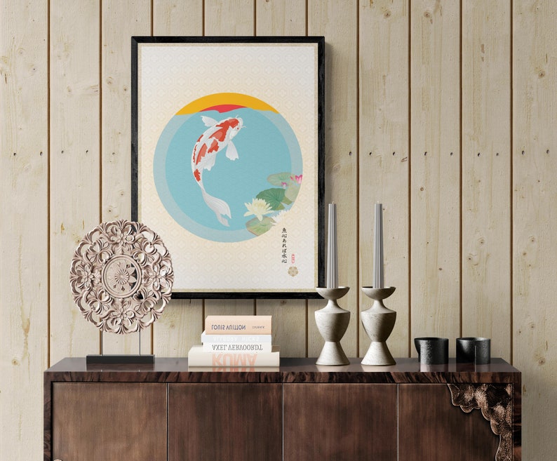 May include: A framed print of a koi fish swimming in a circle with water lilies and Japanese text. The print is on a wooden shelf with two candlesticks, a decorative plate, and three books.
