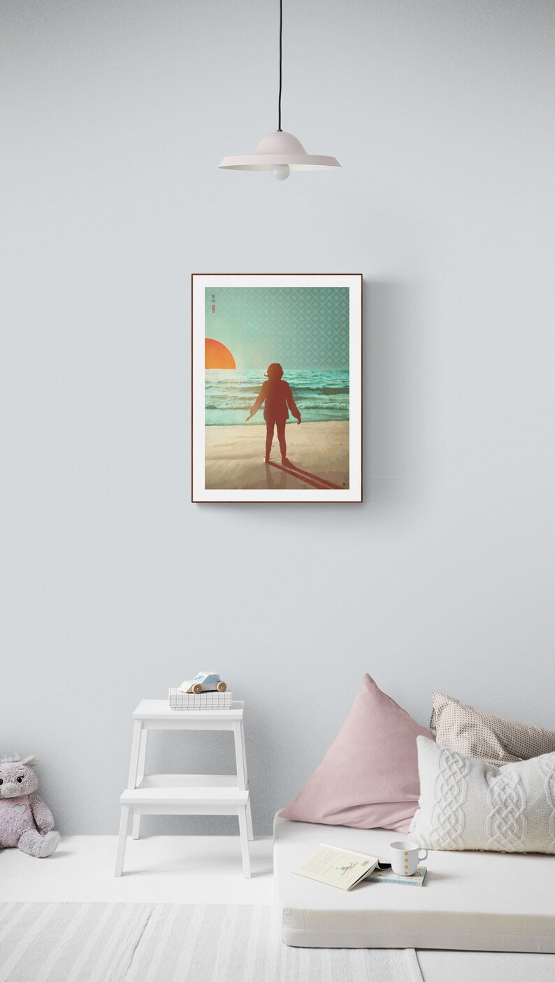 May include: A framed print depicting a person standing on a beach, facing away from the viewer, looking out towards the sea. The sun is setting in the distance, creating a warm glow over the scene. The print has a simple, minimalist style.