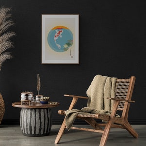 May include: A framed print of a koi fish swimming in a circle with water lilies. The print is hanging on a black wall above a wooden chair with a woven seat and a beige throw blanket.