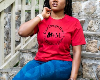May include: A red t-shirt with a black circle design that says "Design Your Here M+M Your Design Here".