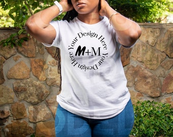 May include: White t-shirt with a black circle design that says "Design Your Here M+M Here Your Design".