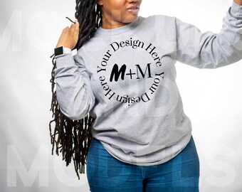 May include: A gray long-sleeved sweatshirt with a black circle design that says "Design Your Here M+M Your Design Here".