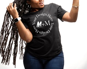 May include: A black t-shirt with a white circle design that says "Design Your Here M+M Here Your Design".