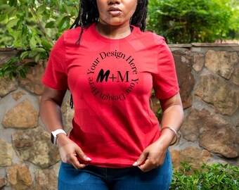 May include: A red t-shirt with a black circle design that says "Design Your Here M+M Here Your Design".