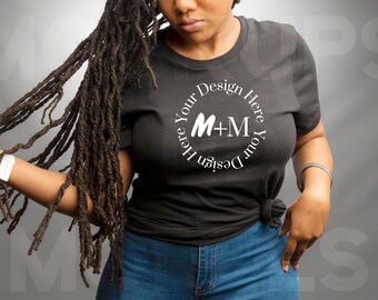 May include: A black t-shirt with a white circle design that says "Design Your Here Your Design Here" with the letters M+M in the center.