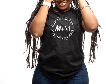 May include: A black t-shirt with a white circle design that says "Design Your Here M+M Your Design Here".