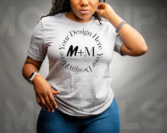 May include: A gray t-shirt with a black circle design that says "Design Your Here M+M Your Design Here".