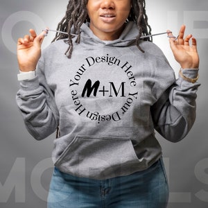 May include: A gray hooded sweatshirt with a black circle design that says "Design Your Here M+M Design Your Here".
