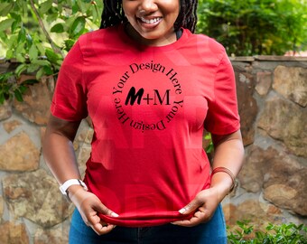 May include: Red t-shirt with a black circle design that says "Design Your Here M+M Here Your Design".