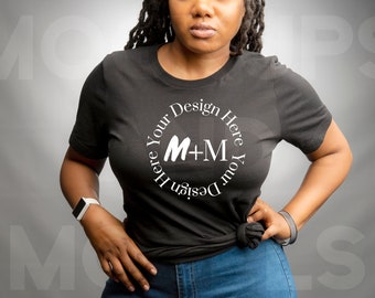 May include: A black t-shirt with a white circle design that says "Design Your Here Your Design Here" with the letters M+M in the center.