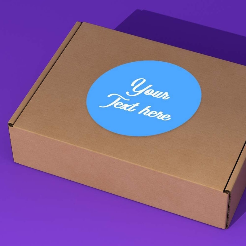 Pu&ograve; includere: Una scatola di cartone marrone con un adesivo circolare blu che dice "Your Text Here" in testo bianco.