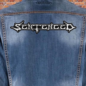 May include: A blue denim jacket with a white "SENTENCED" patch on the back.