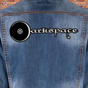 May include: A blue denim jacket with a black and white patch on the back. The patch features a circle with a pentagram inside and the text "Darkspace" in a stylized font.