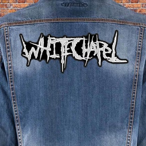 May include: A denim jacket with a white embroidered patch that says "Whitechapel" on the back.