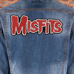 May include: A blue denim jacket with a red and black "Misfits" patch sewn on the back.