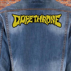 May include: A denim jacket with a yellow embroidered patch that says "DOPETHRONE" on the back.