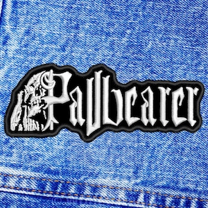 May include: Black and white embroidered patch with the word "Pallbearer" in white lettering on a black background. A skull with a cross bone is on the left side of the patch.