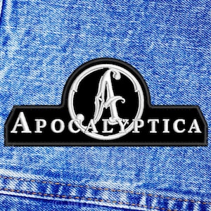 May include: Black and white embroidered patch with the word "APOCALYPTICA" and a stylised letter "A" in a circle.